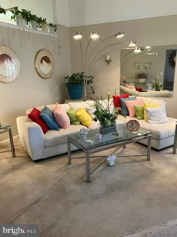 a living room with furniture and a clock