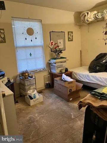 a bedroom with a bed and a baby crib