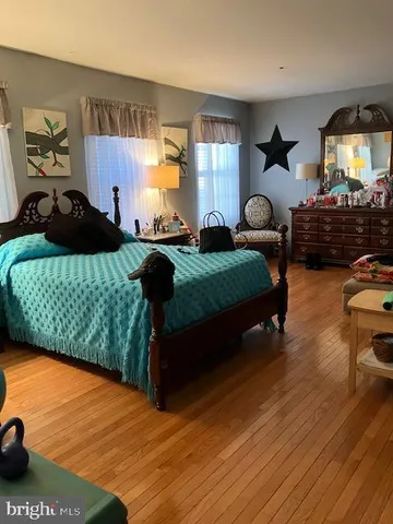 a bedroom with a bed window and dresser