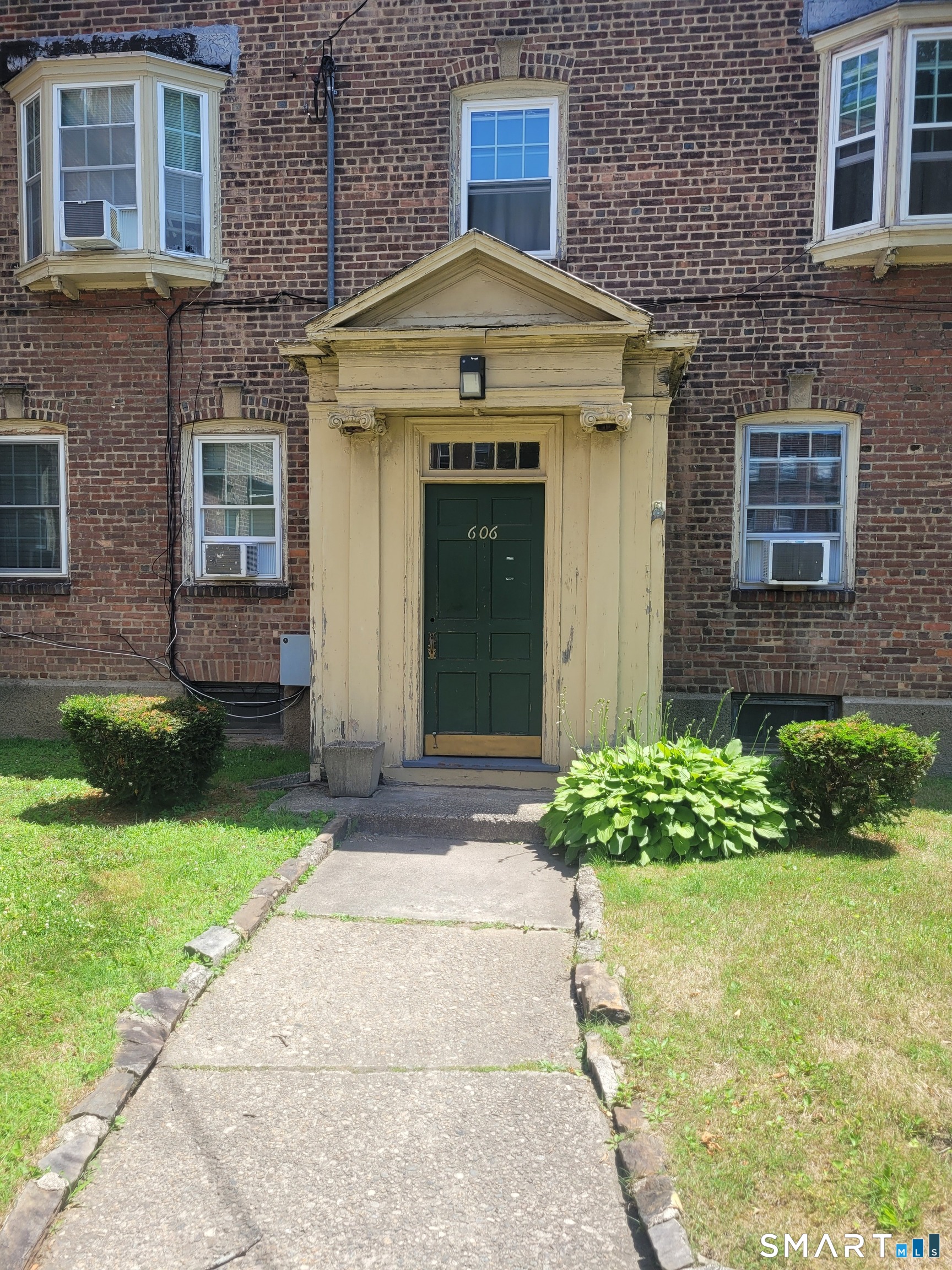 606 Wilmot Avenue, Unit 4 Bridgeport, CT 06607 - Photo 1 of 16 a front view of a house with garden