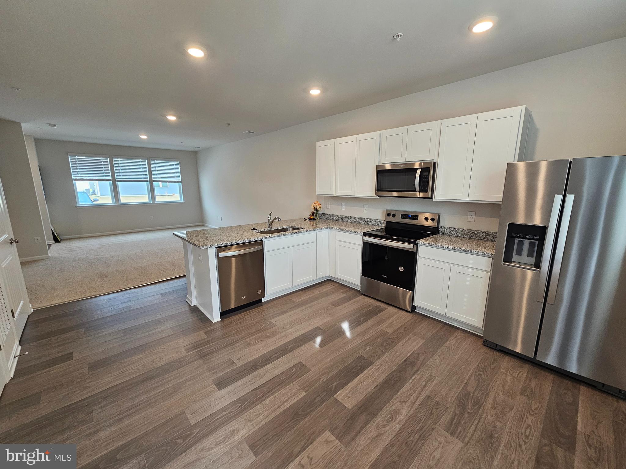 1509 Avon Way Salisbury, MD 21801 - Photo 3 of 19 a kitchen with granite countertop a refrigerator and a stove top oven