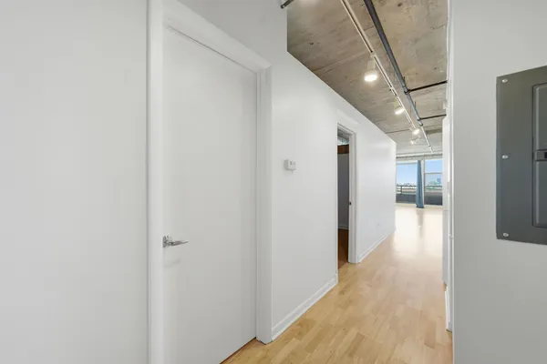 a view of hallway with wooden floor
