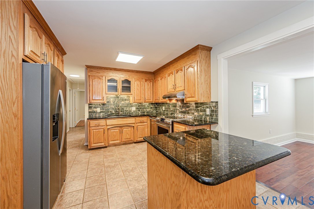 16110 Rowlett Road Chesterfield, VA 23838 - Photo 12 of 23 Kitchen featuring wood cabinetry, black granite co