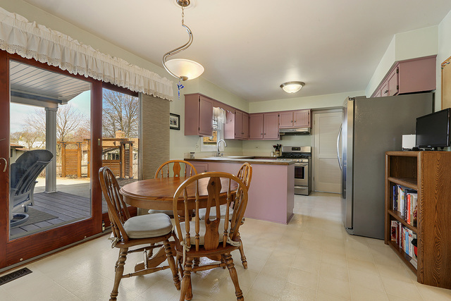 3490 Ronald Road Crete, IL 60417 - Photo 12 of 25 a kitchen with stainless steel appliances granite countertop a refrigerator a stove a sink a dining table and chairs