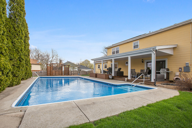 3490 Ronald Road Crete, IL 60417 - Photo 4 of 25 a view of a house with sitting area and swimming pool