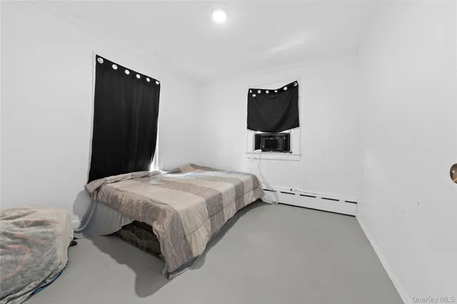 a bedroom with a bed and a television