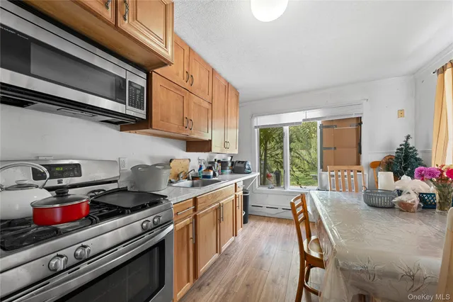 a kitchen with stainless steel appliances kitchen island granite countertop a stove and a sink