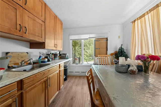 a kitchen with sink refrigerator and window