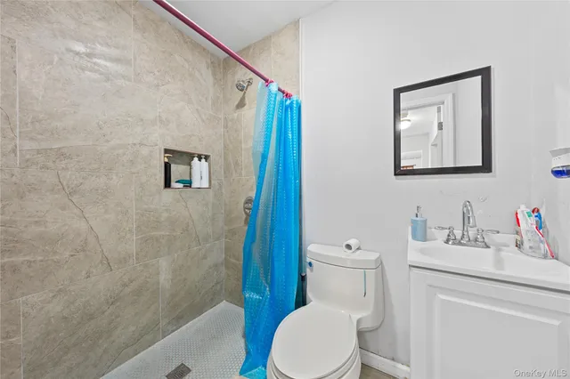 a bathroom with a toilet a sink and shower