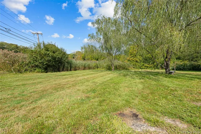 a view of outdoor space with deck and yard