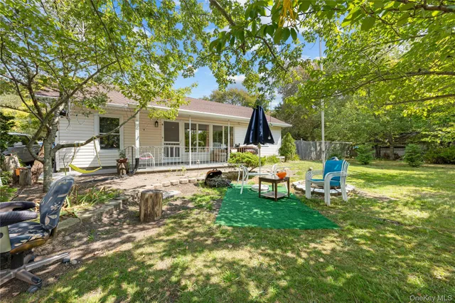 a view of a house with backyard porch and sitting area