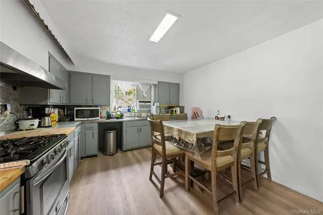 a kitchen with a table chairs stove and cabinets