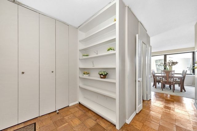 a kitchen with stainless steel appliances granite countertop white cabinets and a stove