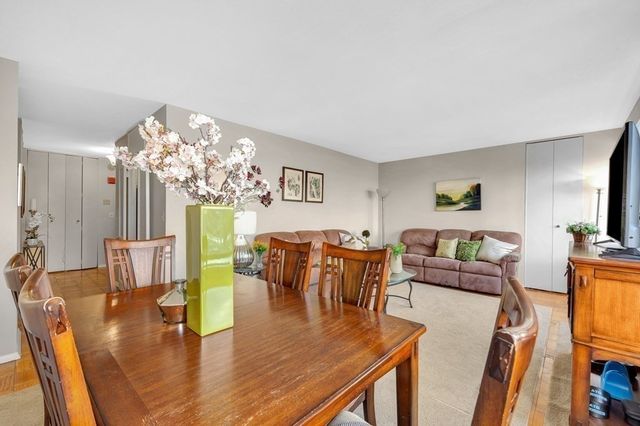 a view of a dining room with furniture and a chandelier