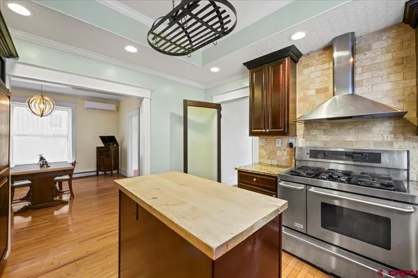 a kitchen with a stove and a refrigerator