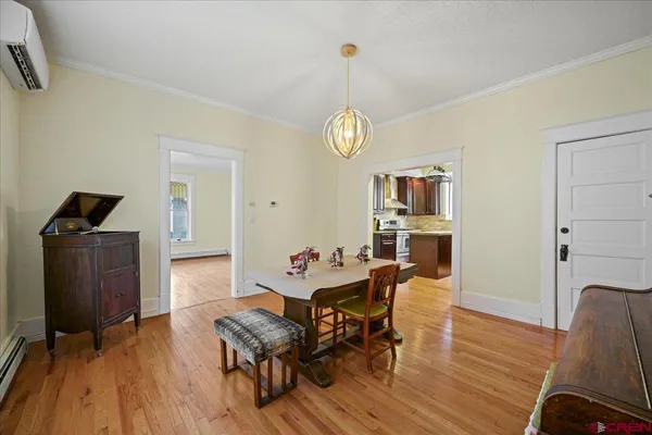 a view of a dining room with furniture and wooden floor