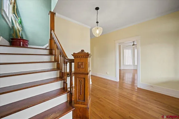 a view of entryway and hall with wooden floor