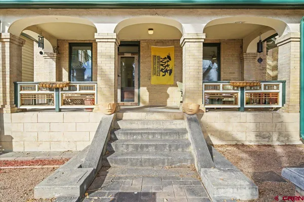 a front view of a house with large windows