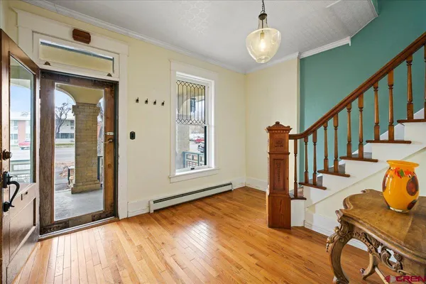 a view of an entryway with wooden floor and windows