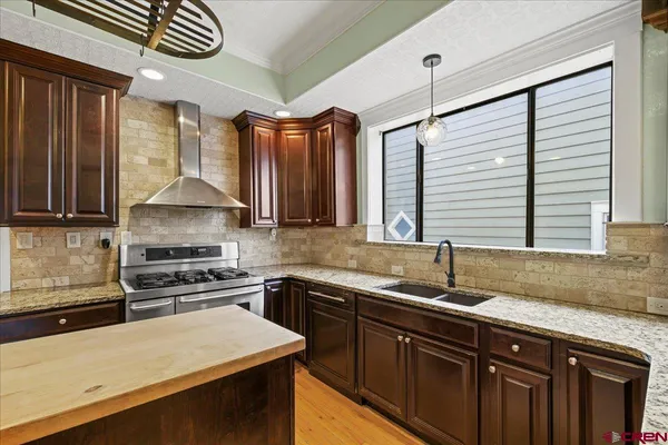 a kitchen with a sink a stove and cabinets