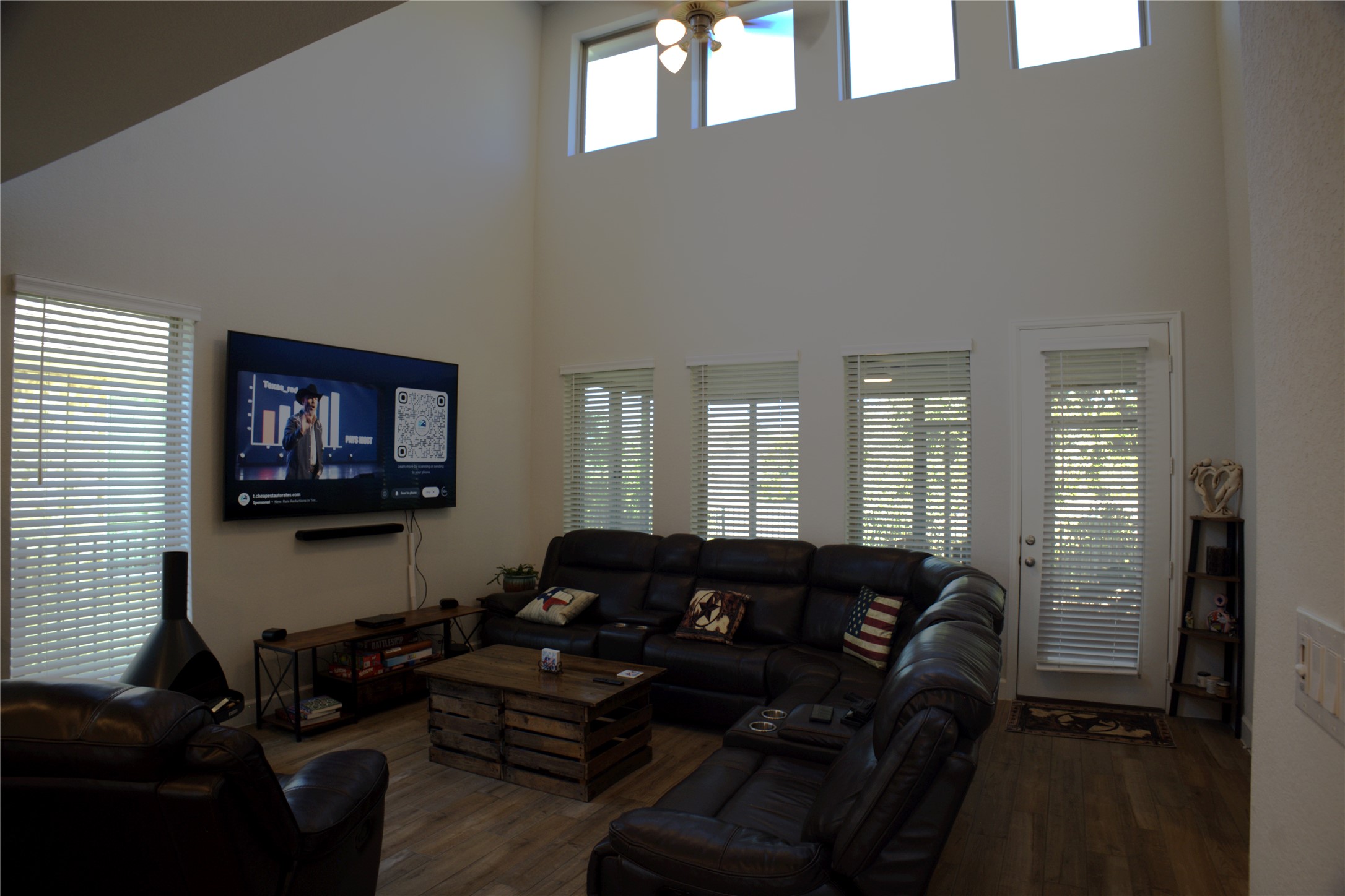 284 Kimble Creek Loop Kyle, TX 78640 - Photo 21 of 37 Living room featuring a high ceiling, healthy amount of natural light, dark wood-type flooring, and a ceiling fan