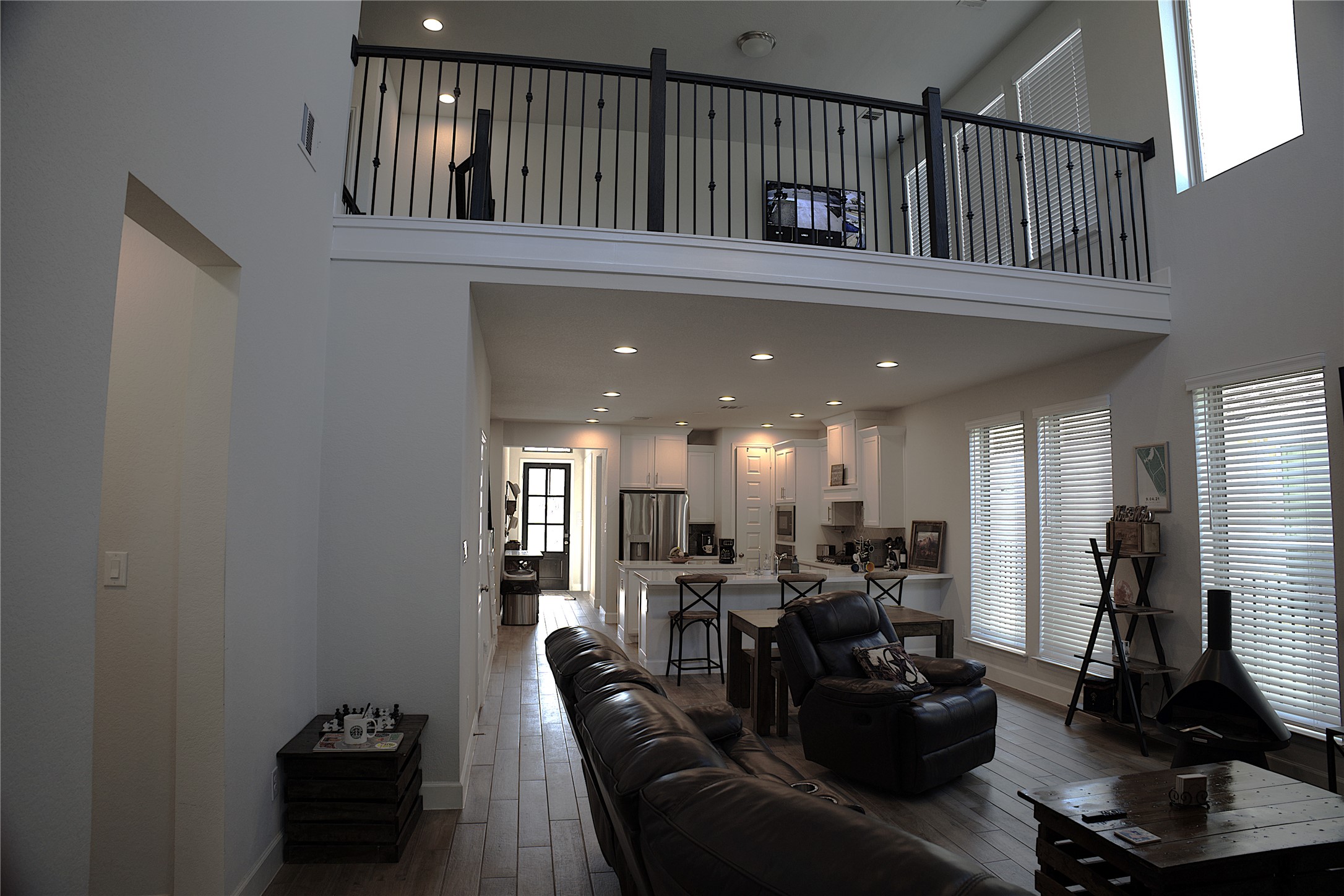 284 Kimble Creek Loop Kyle, TX 78640 - Photo 22 of 37 Living room featuring a towering ceiling, dark wood-style flooring, and recessed lighting