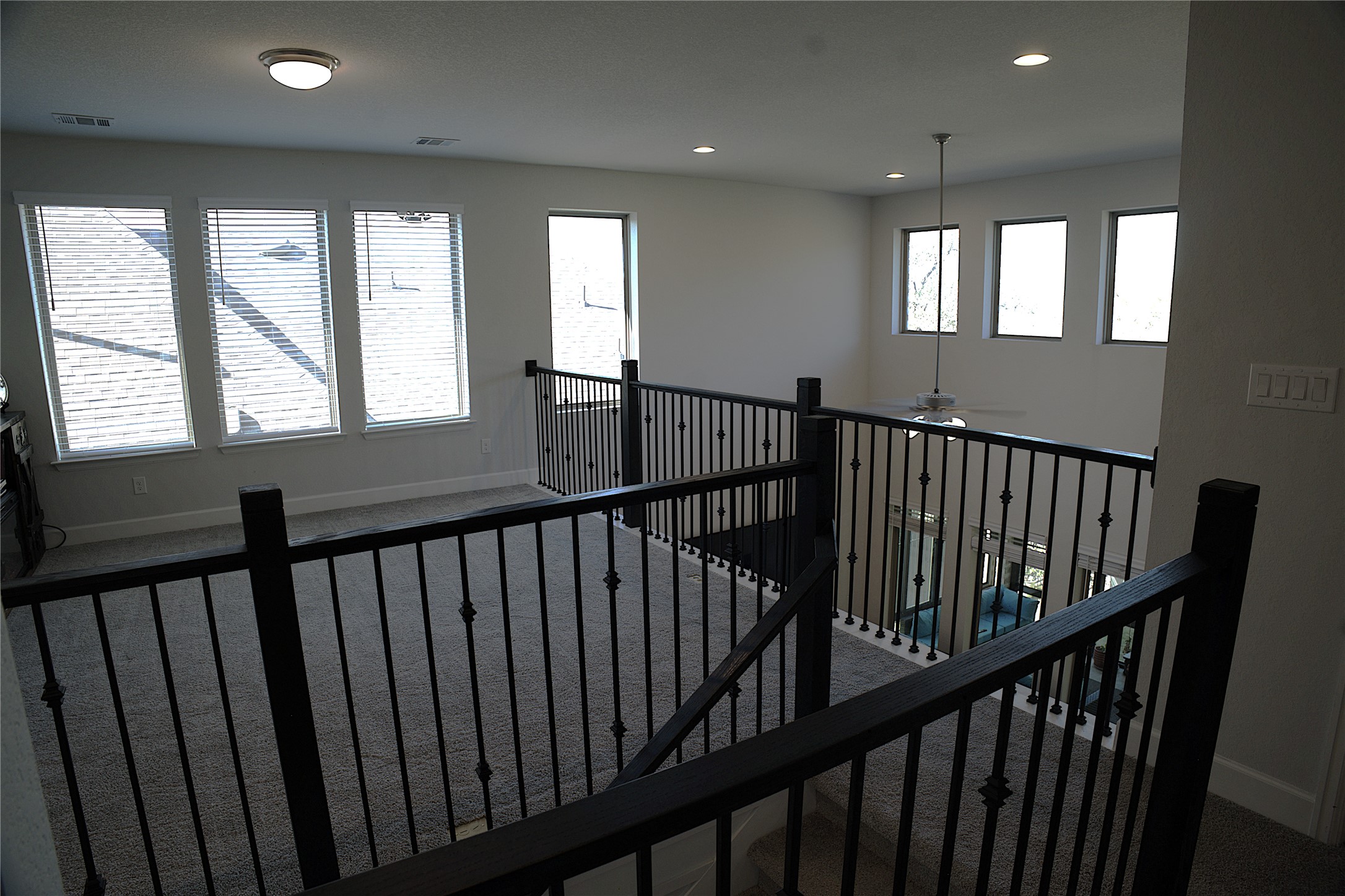 284 Kimble Creek Loop Kyle, TX 78640 - Photo 27 of 37 Hall featuring carpet, recessed lighting, and an upstairs landing