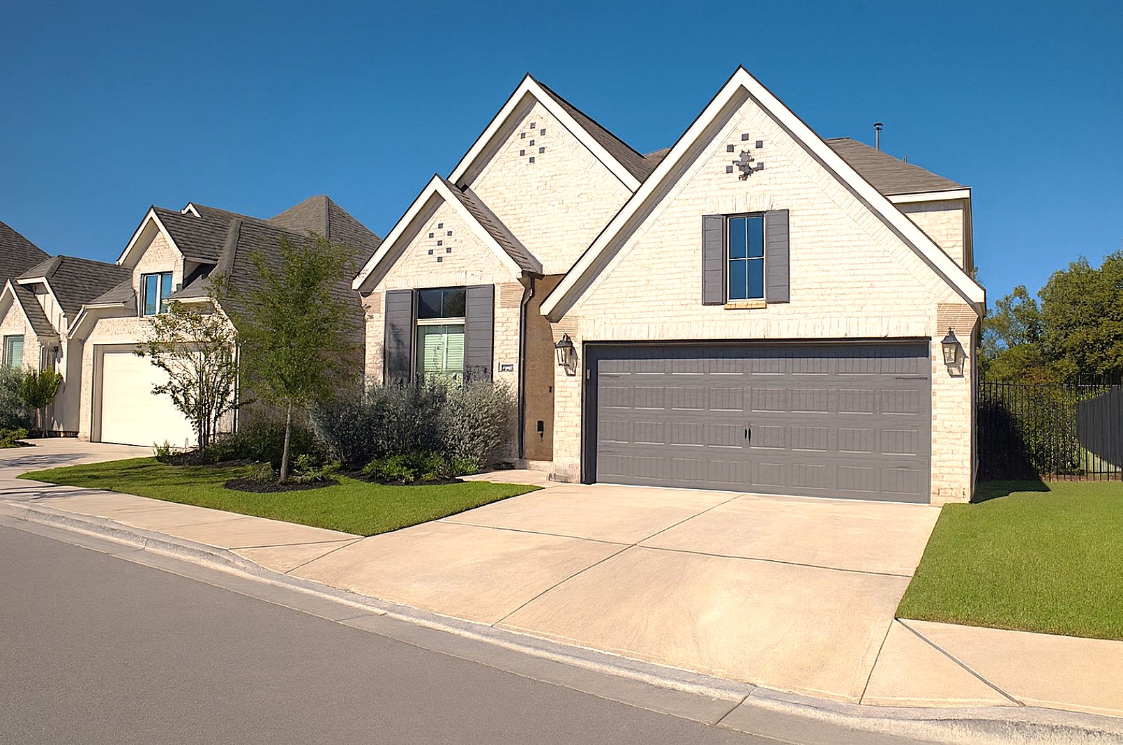 284 Kimble Creek Loop Kyle, TX 78640 - Photo 4 of 37 View of front facade featuring a garage, concrete driveway, and brick siding