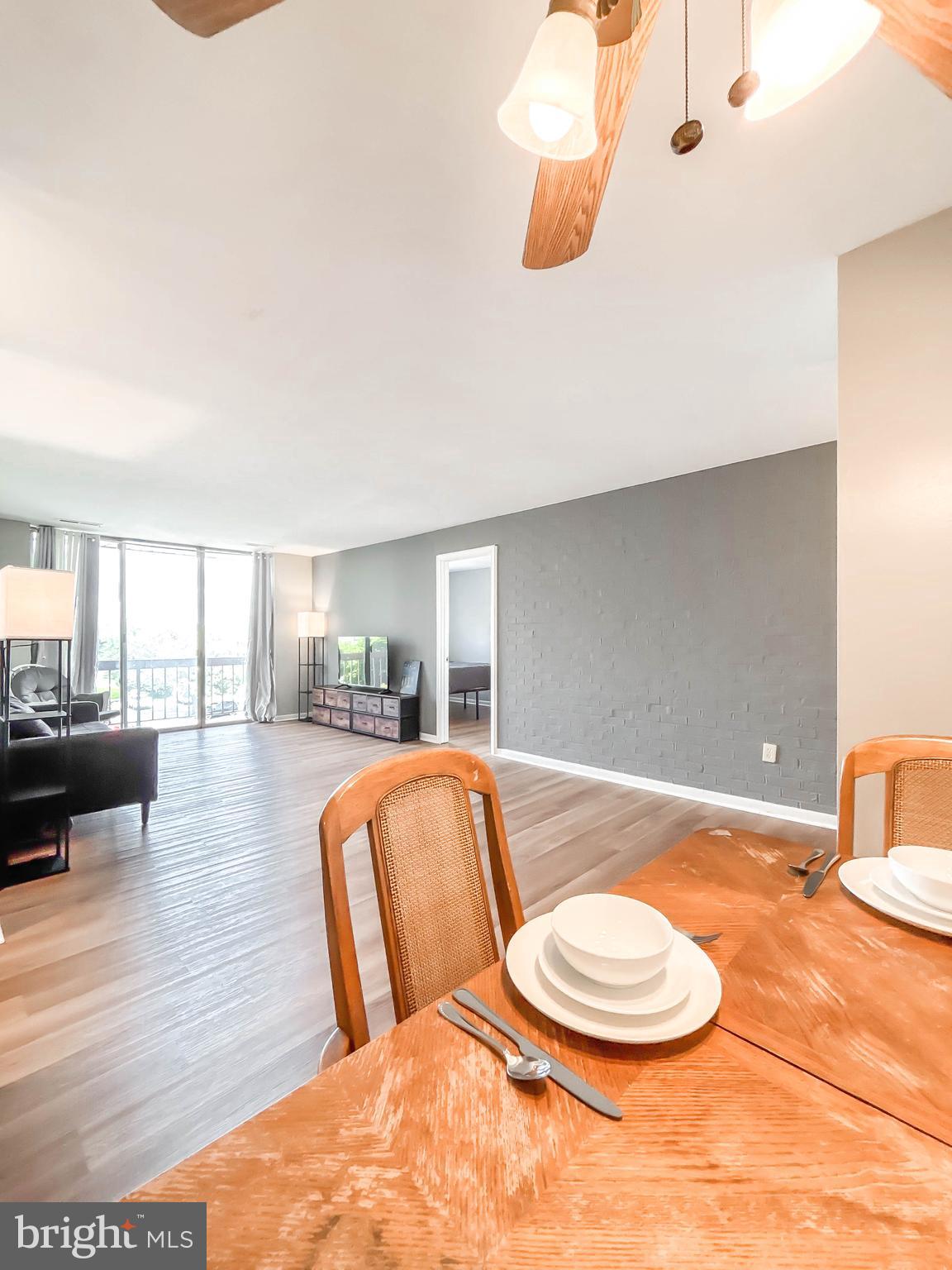 130 Slade Avenue, Unit 414 Baltimore, MD 21208 - Photo 41 of 48 a living room with dining room and wooden floor
