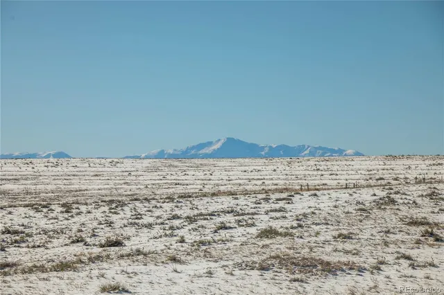 a view of wooden floor and mountains in the background