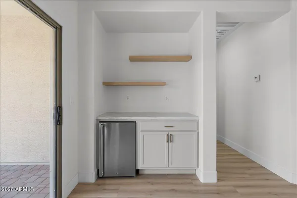 a view of walk in closet with empty racks