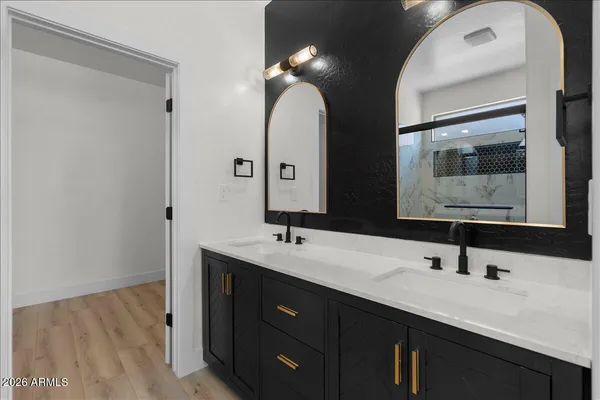 a bathroom with a double vanity sink and a mirror