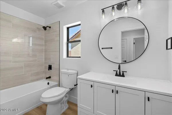 a bathroom with a sink a toilet and a mirror