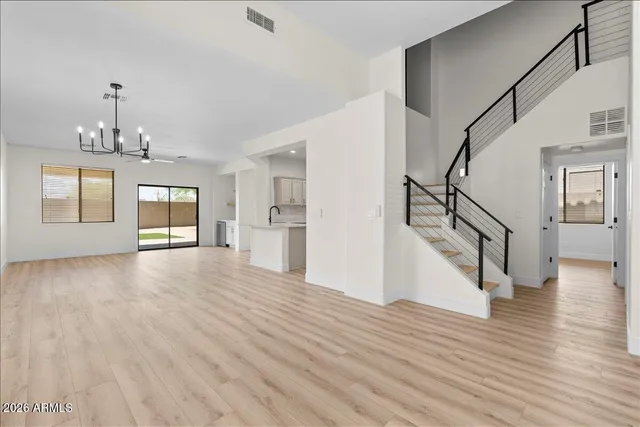 a view of empty room with wooden floor and window