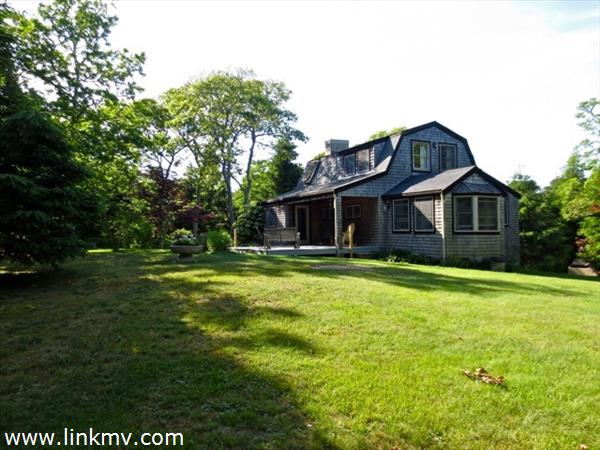 84 Pennywise Path Edgartown, MA 02539 - Photo 1 of 29 a front view of a house with a garden