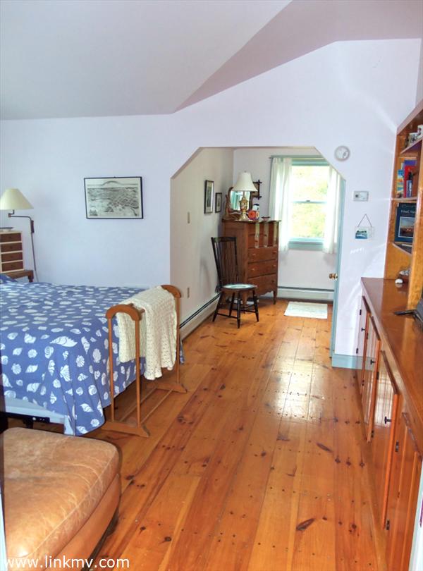 84 Pennywise Path Edgartown, MA 02539 - Photo 23 of 29 a bedroom with furniture and a wooden floor