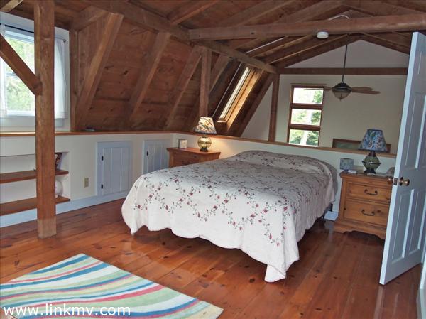 84 Pennywise Path Edgartown, MA 02539 - Photo 25 of 29 a bedroom with a bed and wooden floor