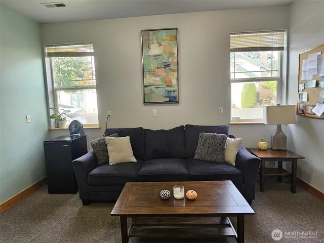 a living room with furniture a table and a window