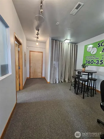 a view of a livingroom with furniture and windows