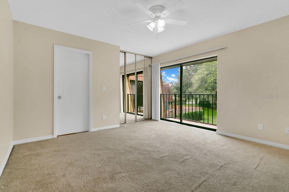 5286 Willow Court, Unit 505 Orlando, FL 32811 - Photo 16 of 33 a view of an empty room with closet and a window
