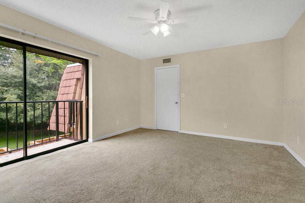 5286 Willow Court, Unit 505 Orlando, FL 32811 - Photo 18 of 33 a view of a big room with windows and chandelier fan