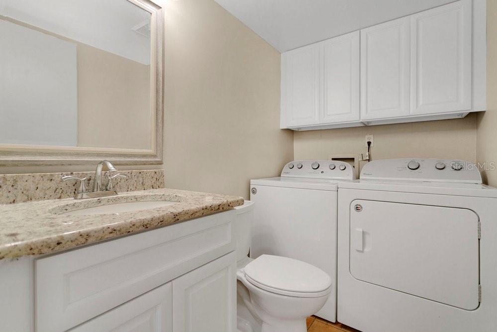 5286 Willow Court, Unit 505 Orlando, FL 32811 - Photo 24 of 33 a utility room with sink dryer and washer