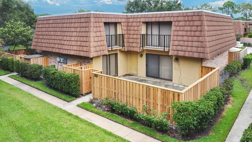 5286 Willow Court, Unit 505 Orlando, FL 32811 - Photo 27 of 33 a view of a house with brick walls and potted plants