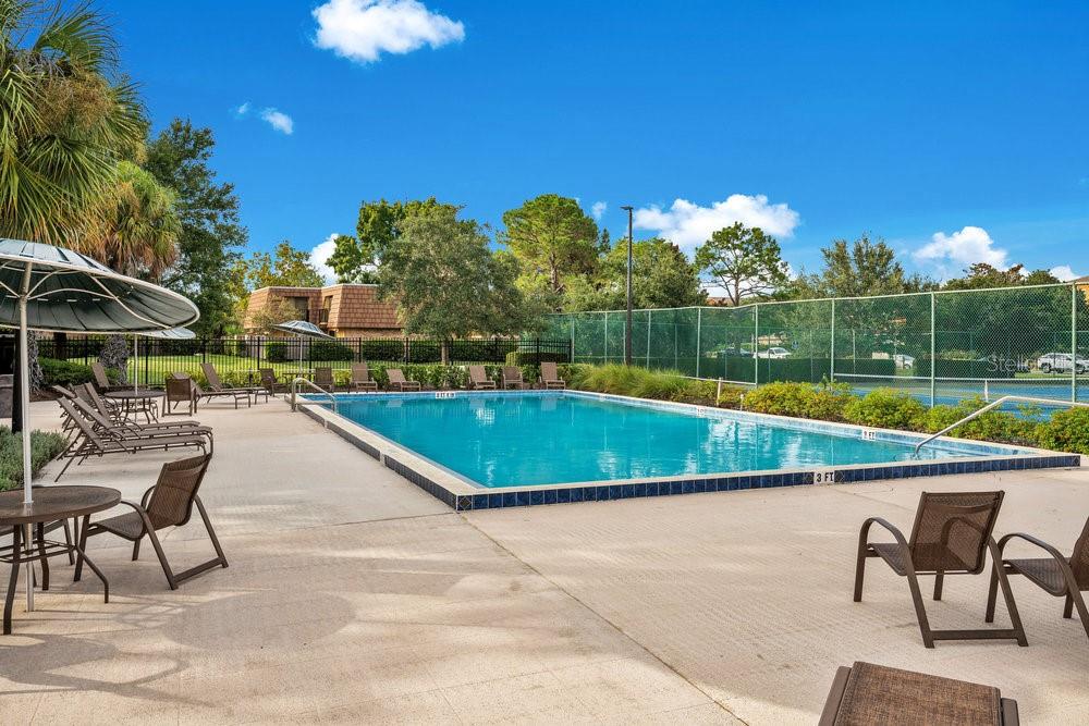 5286 Willow Court, Unit 505 Orlando, FL 32811 - Photo 30 of 33 a view of swimming pool with a lounge chairs