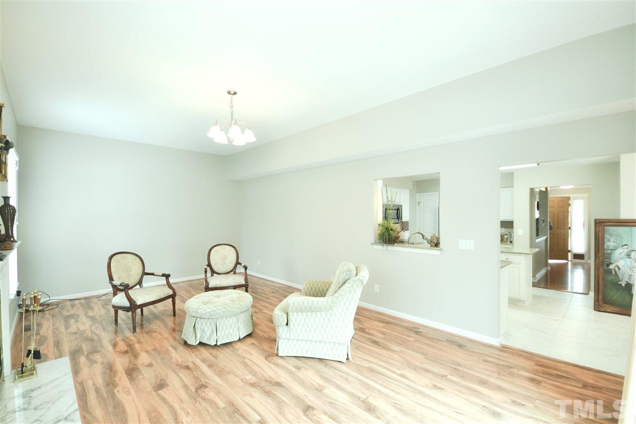 2341 Kendricks Court Raleigh, NC 27613 - Photo 15 of 29 a living room with furniture a table and wooden floor
