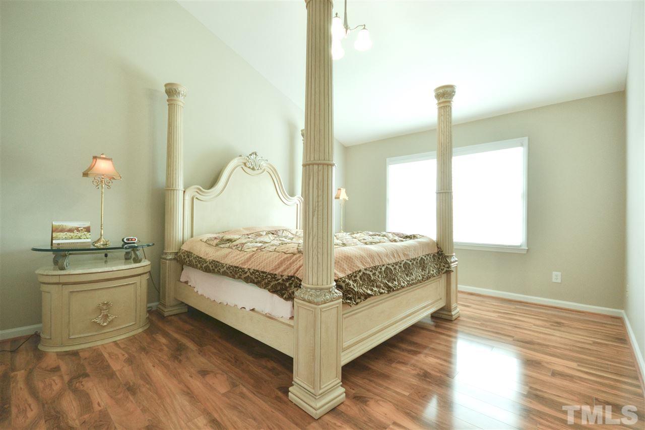 2341 Kendricks Court Raleigh, NC 27613 - Photo 16 of 29 a large bed sitting in a room next to a window