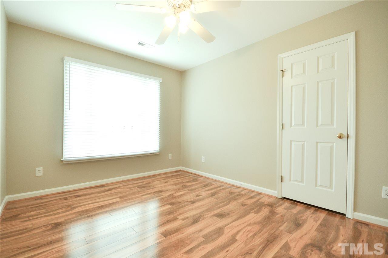 2341 Kendricks Court Raleigh, NC 27613 - Photo 22 of 29 an empty room with wooden floor and windows