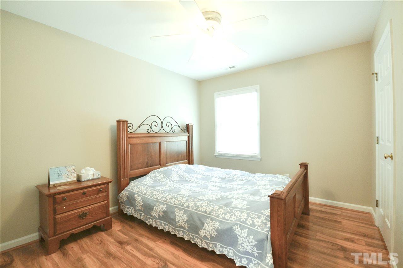 2341 Kendricks Court Raleigh, NC 27613 - Photo 23 of 29 a bedroom with a bed and wooden floor