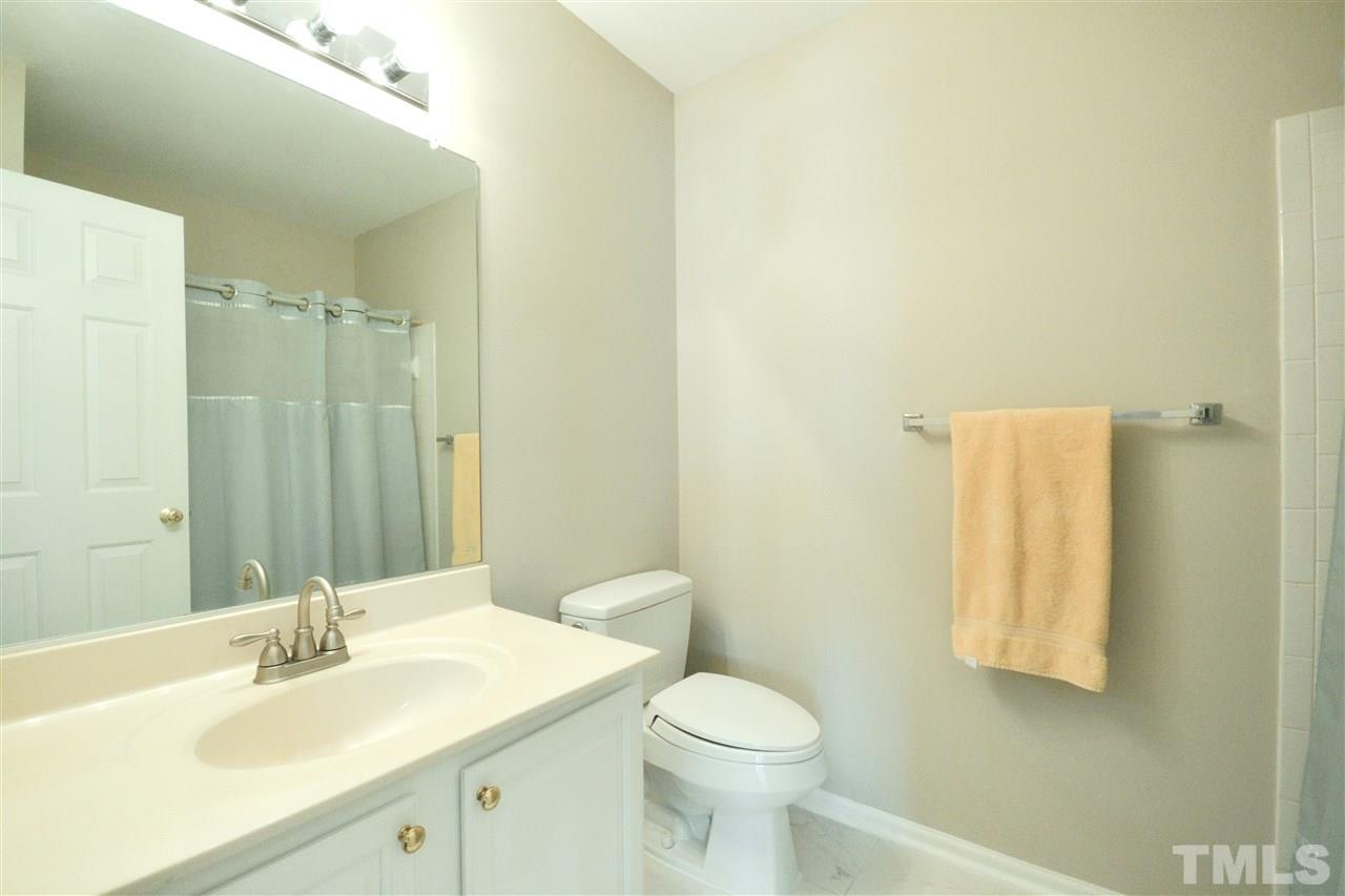 2341 Kendricks Court Raleigh, NC 27613 - Photo 24 of 29 a bathroom with a sink and a mirror