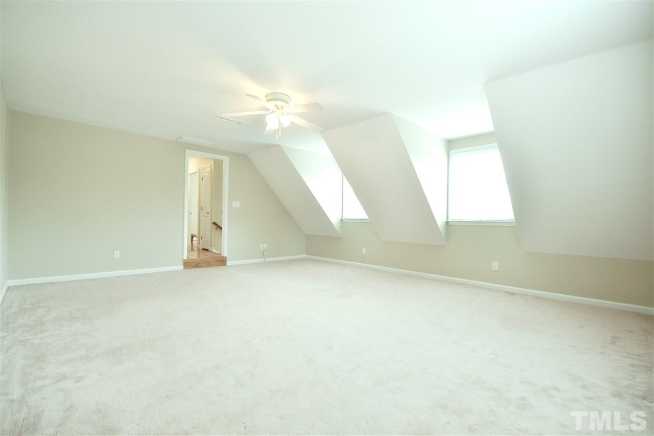 2341 Kendricks Court Raleigh, NC 27613 - Photo 25 of 29 an empty room with a windows and ceiling fan
